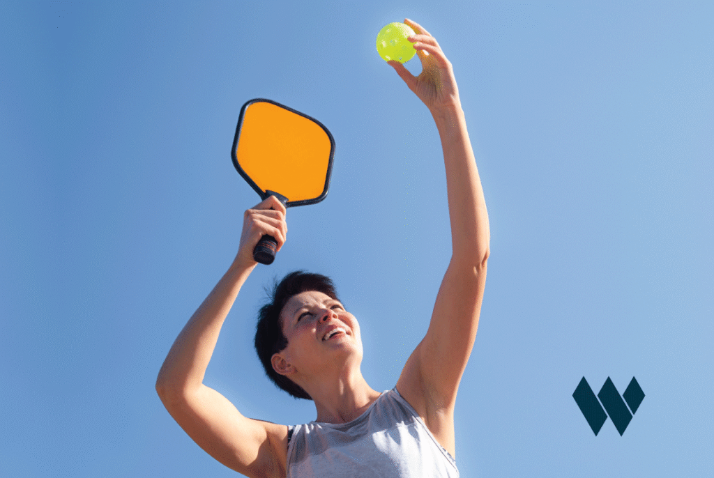 person getting ready to serve a pickleball